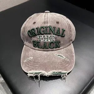 Distressed washed baseball cap with green embroidered letters for retro street style.