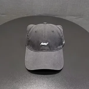 Detail view of a dark grey cat ear baseball cap, soft top casual street style hat with embroidery.