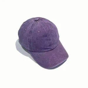 Close-up detail of the purple washed denim baseball cap showing premium vintage fabric texture.