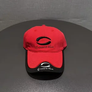 Stylish red and black colorblock baseball cap with detailed embroidery for outdoor sun protection.