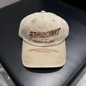 Washed cotton baseball cap with stylish brown embroidery lettering, casual sun protection hat.