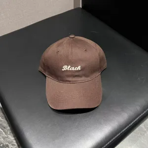 Brown baseball cap with white embroidered lettering. Soft top design for casual wear.
