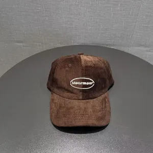 Vintage brown corduroy baseball cap with embroidered logo, wide brim stylish casual hat.
