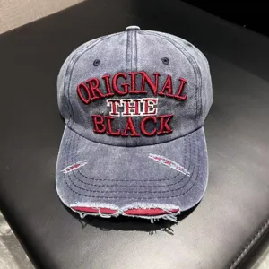 Vintage washed denim baseball cap with distressed brim and embroidered original black letter details.