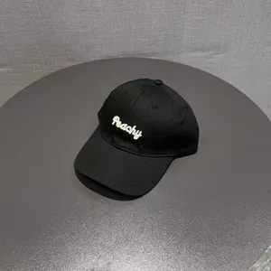 Black cotton baseball cap with stylish white embroidered Peachy logo for casual daily wear