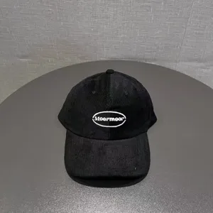 Black corduroy baseball cap with embroidered Moormoor logo, wide brim stylish couple hat.
