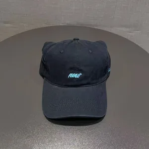 Details of black cat ear baseball cap, soft crown streetwear style with front embroidery.