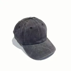 Close-up of the vintage washed denim baseball cap texture, showing brim and eyelets.