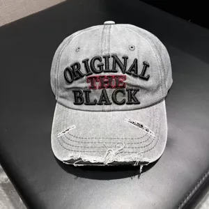 Vintage washed denim baseball cap for women with distressed brim and embroidered letter logo.