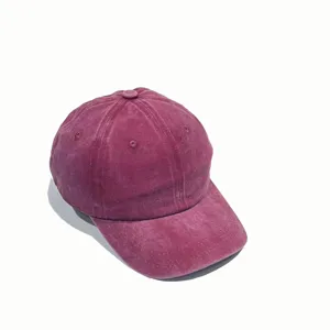 Close-up detail of the vintage washed maroon baseball cap showing distressed fabric and stitching.