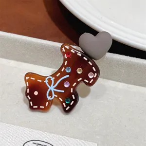 Detail shot of cute puppy acetate hair clip with colorful rhinestones and sweet bow decoration.