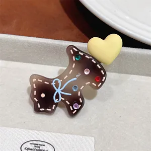 Cute acetate puppy hair clip with colorful rhinestones and bow design for sweet daily hairstyles.