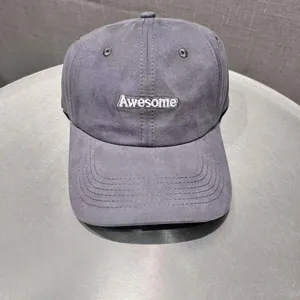 Grey embroidered baseball cap detail showing premium stitching and the Awesome text design.