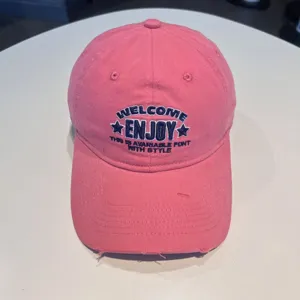 Pink embroidered baseball cap with WELCOME ENJOY lettering, casual stylish streetwear hat.