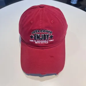 Classic red embroidered baseball cap with stylish front text lettering for men and women.