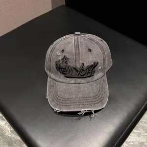 Vintage washed baseball cap with distressed brim and bold embroidered New York lettering.