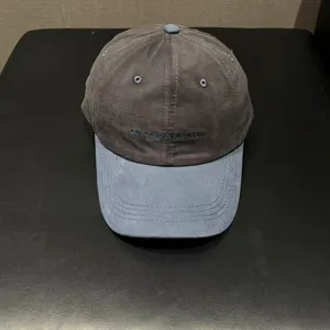 Detail view of the contrast color baseball cap with front embroidery letters for casual wear.