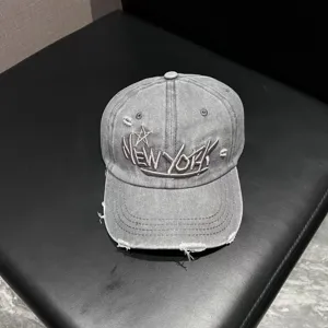Detailed view of the vintage washed denim baseball cap featuring unique New York embroidery.