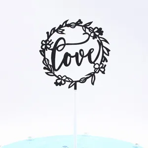 Black floral Love cake topper detail shot, perfect for wedding, anniversary, and party decoration.