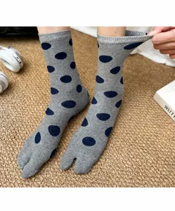 Gray polka dot split toe socks detail view, cozy knit texture, retro vintage style detail.