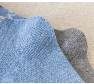 Thickened thermal winter wool mid-tube socks with cozy knit texture and retro style.