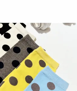 Detailed shot of women's contrast polka dot split toe mid-calf socks showing soft fabric.
