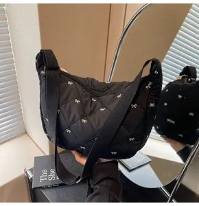 Black quilted bow shoulder crossbody dumpling bag for women, casual commuter daily fashion.