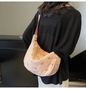 Pink quilted dumpling bag featuring cute bow embroidery, soft shoulder strap and detail view.