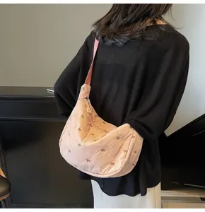 Detailed view of the pink quilted bow shoulder dumpling bag, showing soft texture and design.