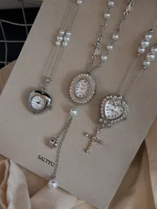 Detailed view of exquisite pearl long sweater necklace featuring vintage watch and cross pendants.