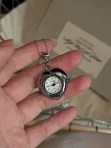 Silver heart-shaped pocket watch necklace, vintage quartz pendant chain, unique niche jewelry.