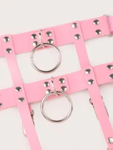 Close-up detail of pink faux leather punk garter belt with metal rings and cool rivets.