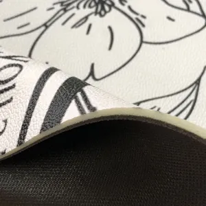 Closeup detail showing multi-layer construction of waterproof leather floor mat with floral print.