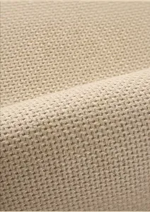 Close-up detail of beige faux linen woven texture fabric mat surface clearly showing pattern.