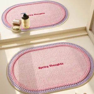 Cream style woven oval bath mat with embroidery design for bathroom non slip floor.