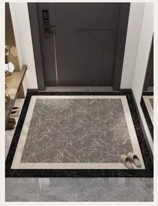 Detail view of an entryway door mat featuring a stylish grey floral pattern and durable border.