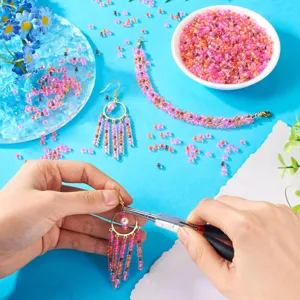 DIY handmade glass seed beads and jewelry making detail showcasing vibrant pink and orange colors.