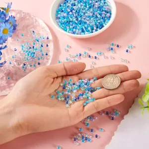 Detailed close-up shot of colorful glass seed beads displayed on a clean hand and styled setting.