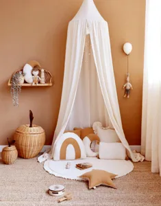 Cozy boho children room setup featuring a beige canopy tent and round crawling mat for kids.