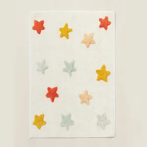 Charming tufted star detail on soft plush nursery rug, cozy children room floor decor.