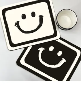 Close-up detail of minimalist black and white smiley face kitchen draining mat and coaster.