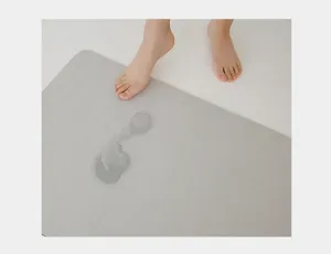 Soft diatom mud bath mat detail showing instant water absorption footprint effect clearly.