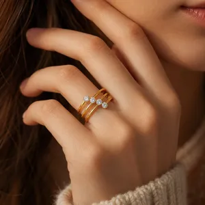 Close-up detail of the multi-band gold zircon ring worn on a hand, showing sparkling stone shine.