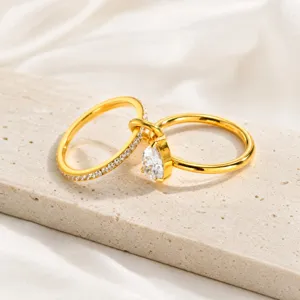 Gold stainless steel interlocking rings set with sparkling cubic zirconia stones.