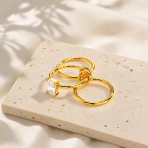 Detail view of stylish stainless steel multi-ring golden zirconia ring for women.