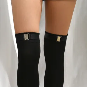 Close-up of black over-the-knee socks with elastic leg ring and metal buckle accessory detail.