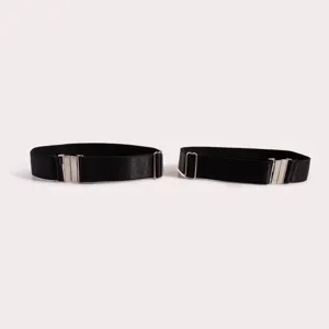 Black elastic boot straps garter belts with silver metal adjustable buckles, detail shot.