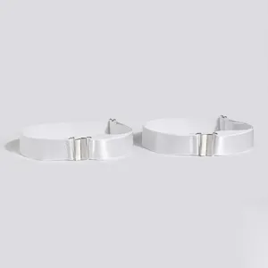 White elastic boot straps with silver metal buckles, detailed view of texture and clasp.