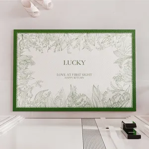 Luxury leather texture doormat with botanical sketch and green border, top-down view.