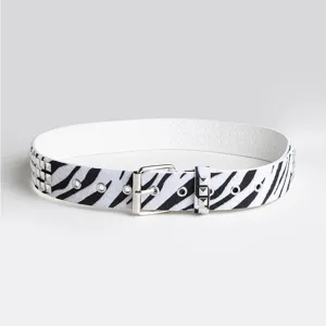 Close-up detail of a fashion zebra print women's belt with silver buckle and square studs.